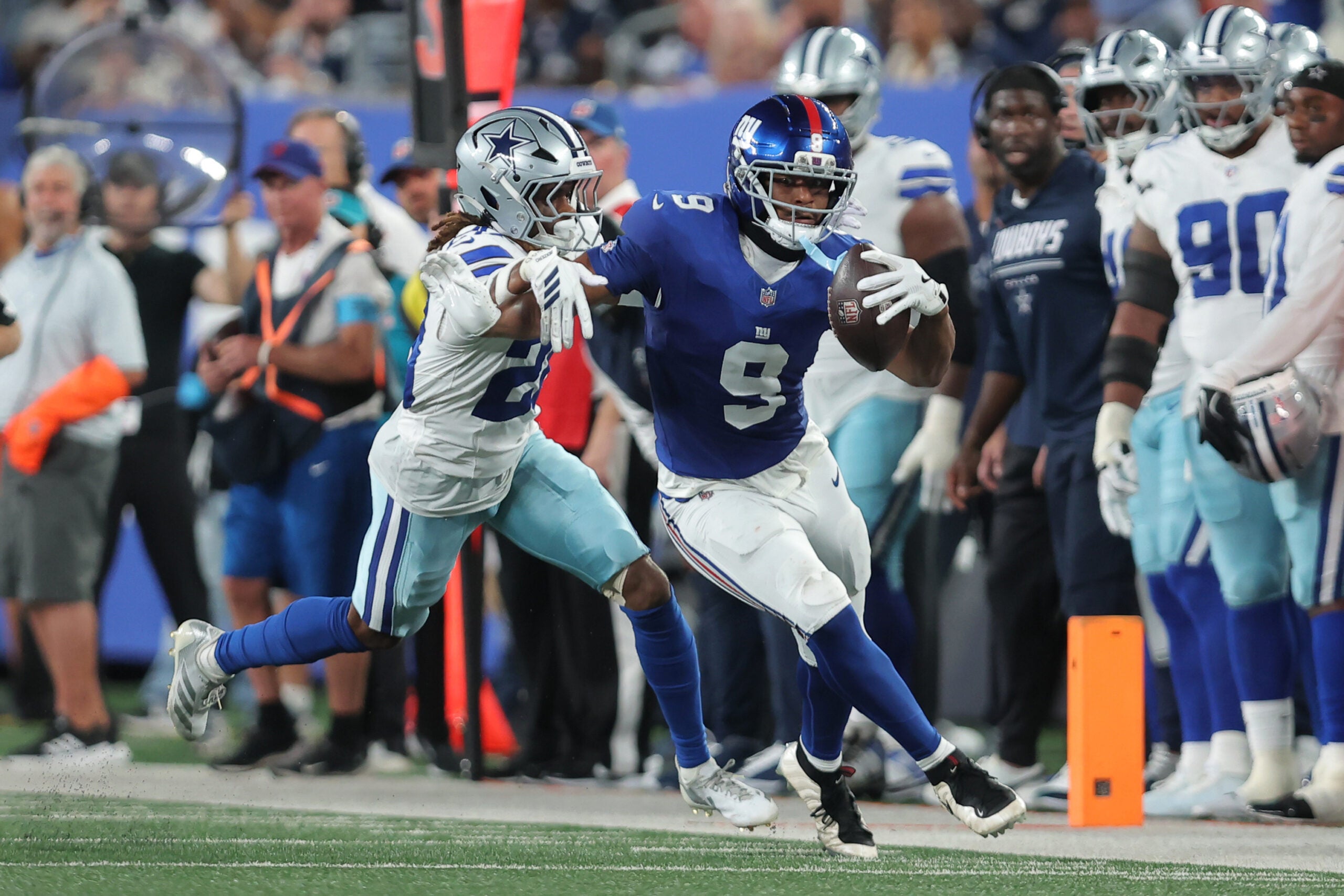 Sep 13, 2026; East Rutherford, New Jersey, USA; New York Giants tight end Isaiah Likely (9) carries the ball defended by Dallas Cowboys cornerback Shavon Revel Jr. (28) during the second quarter at MetLife Stadium.