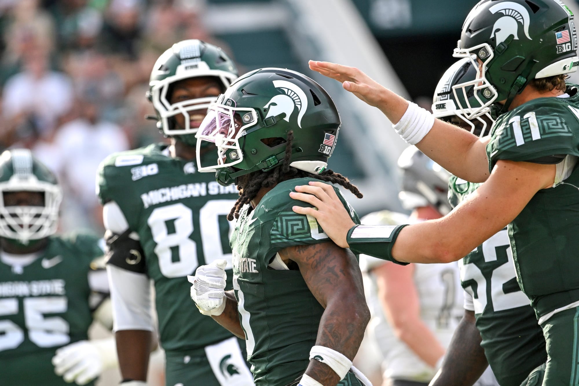 Michigan State running back Cam Edwards celebrates his touchdown with quarterback Alessio Milivojevic, right, during the third quarter against Eastern Michigan on Saturday, Sept. 12, 2026, at Spartan Stadium in East Lansing.
