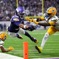 Sep 13, 2026; Minneapolis, Minnesota, USA; Minnesota Vikings wide receiver Justin Jefferson (18) reaches for a touchdown during the second half against Green Bay Packers cornerback Keisean Nixon (25) at U.S. Bank Stadium.