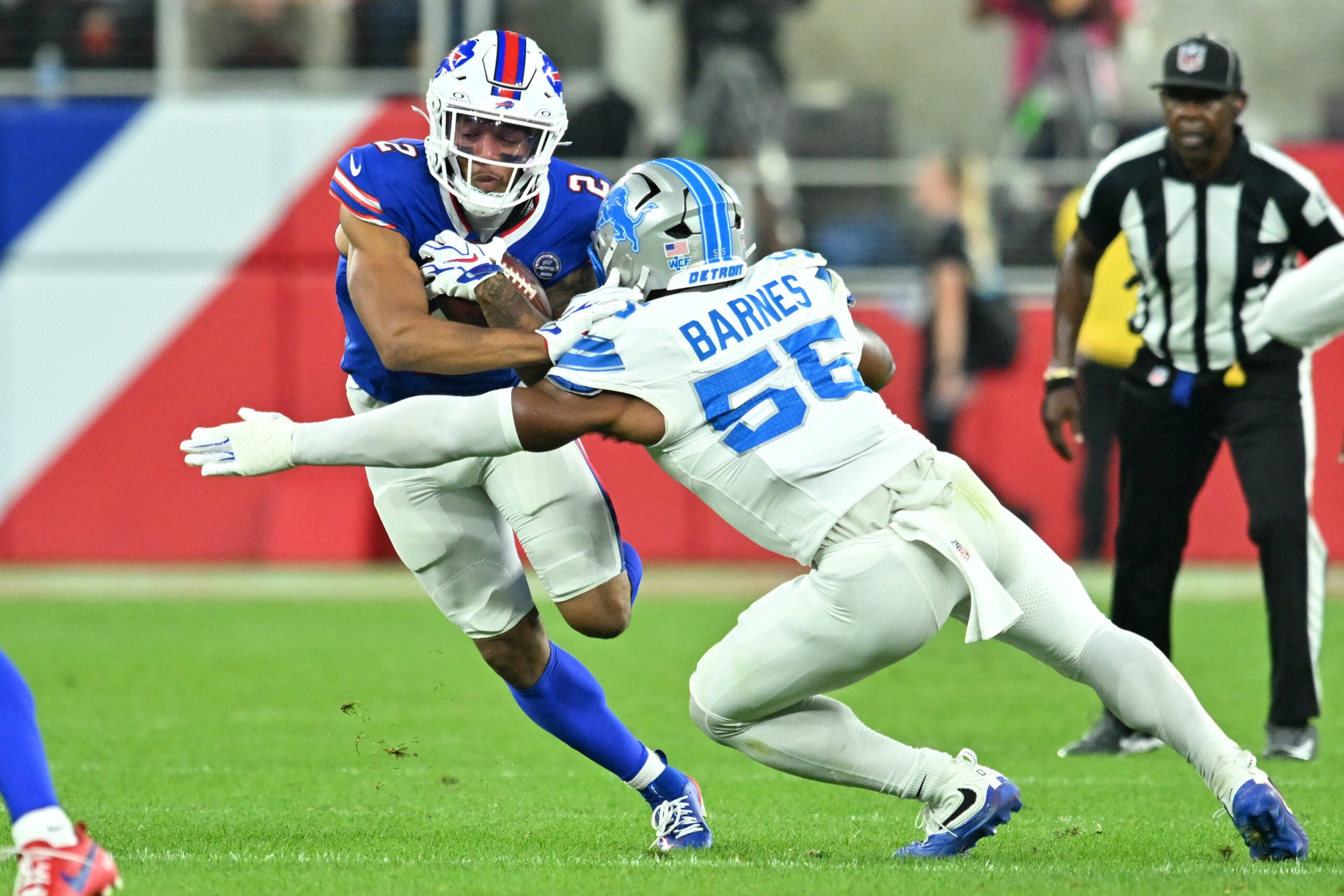 Sep 17, 2026; Orchard Park, New York, USA; Buffalo Bills wide receiver DJ Moore (2) runs against Detroit Lions linebacker Derrick Barnes (55) during the first half at New Highmark Stadium.