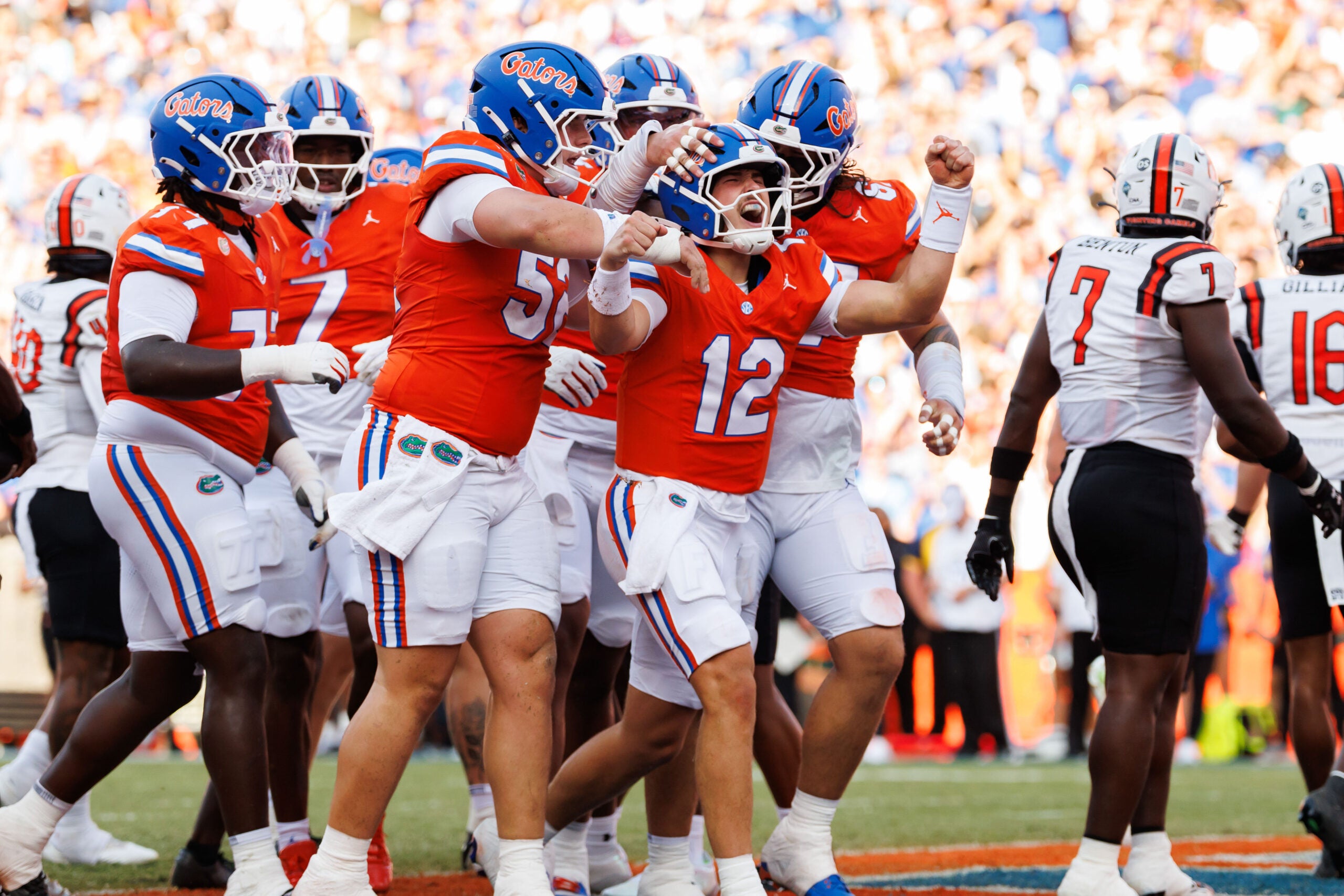 Sep 12, 2026; Gainesville, Florida, USA; Florida Gators quarterback Aaron Philo (12) celebrates after scoring a touchdown with Florida Gators offensive lineman Harrison Moore (52) and Florida Gators offensive lineman TJ Shanahan Jr. (67) against the Campbell Fighting Camels during the first half at Ben Hill Griffin Stadium.