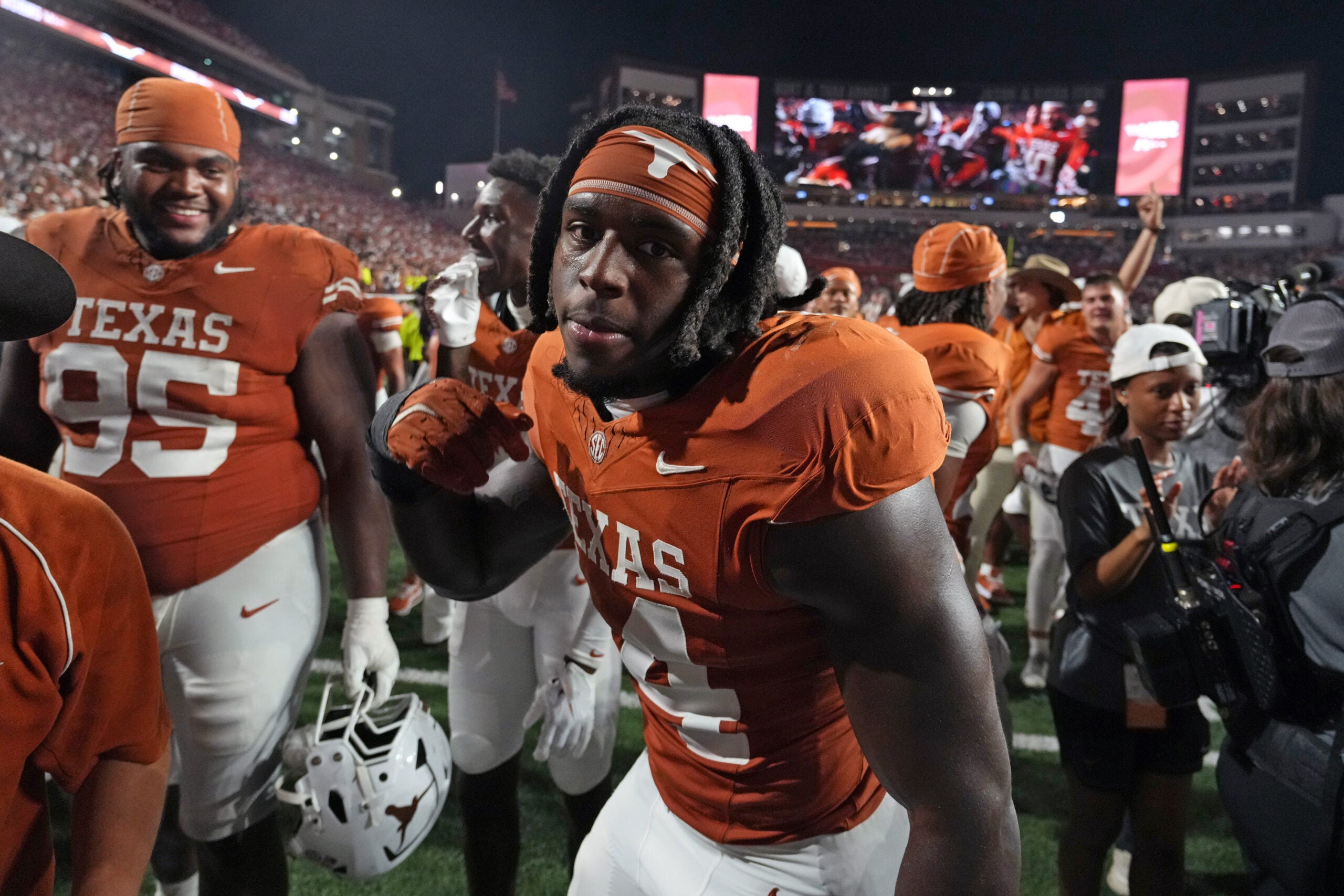 Sep 12, 2026; Austin, Texas, USA; Texas Longhorns edge Brad Spence (14) celebrates with teammates after defeating the Ohio State Buckeyes at Darrell K Royal-Texas Memorial Stadium.