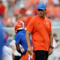 Sep 19, 2026; Auburn, Alabama, USA; Florida Gators head coach Jon Sumrall watches his team warm up before the game against the Auburn Tigers at Jordan-Hare Stadium.