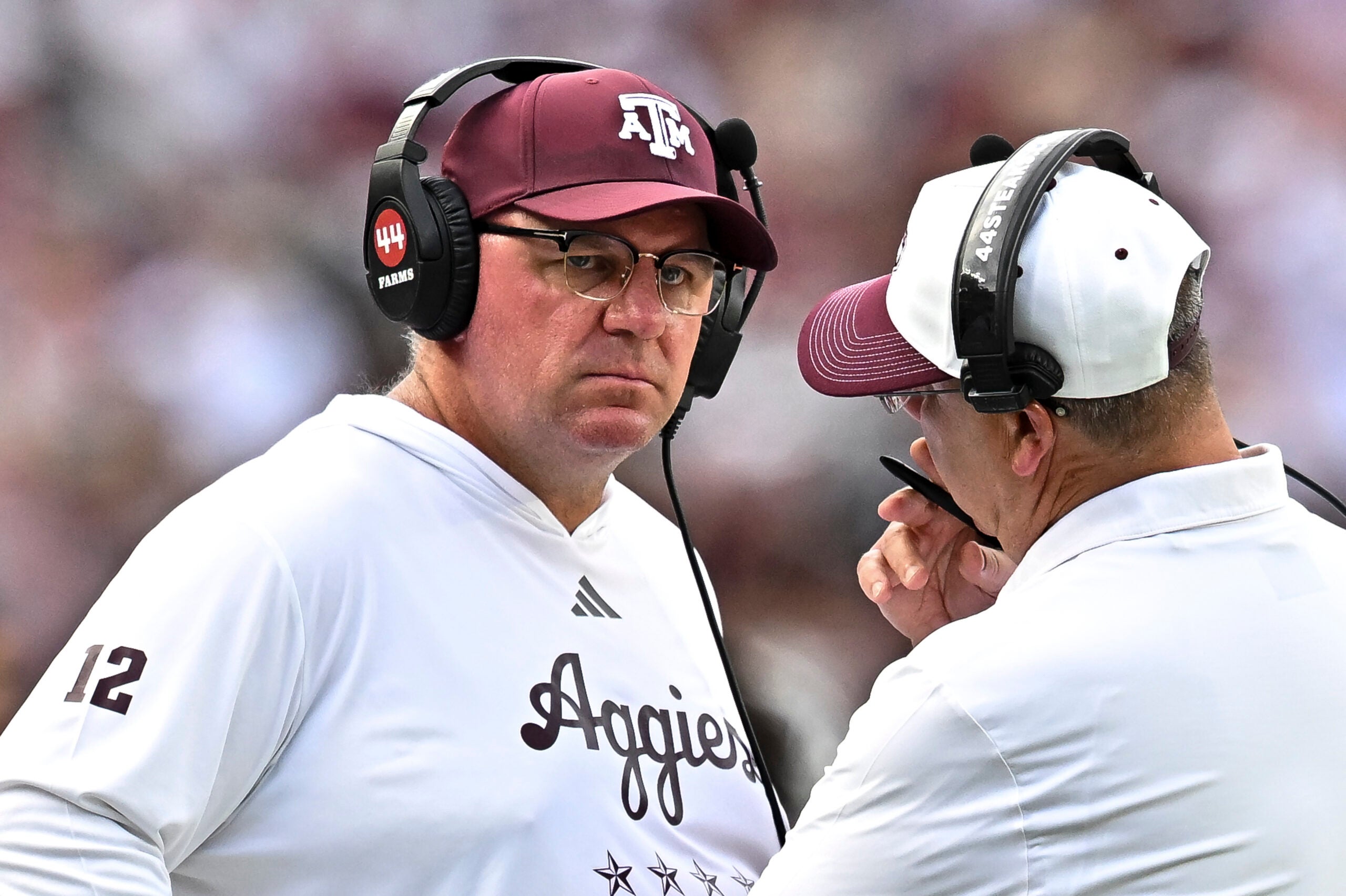 Sep 19, 2026; College Station, Texas, USA; Texas A&M Aggies head coach Mike Elko speaks with a member of his coaching staff during a time-out in the fourth quarter against the Kentucky Wildcats at Kyle Field.