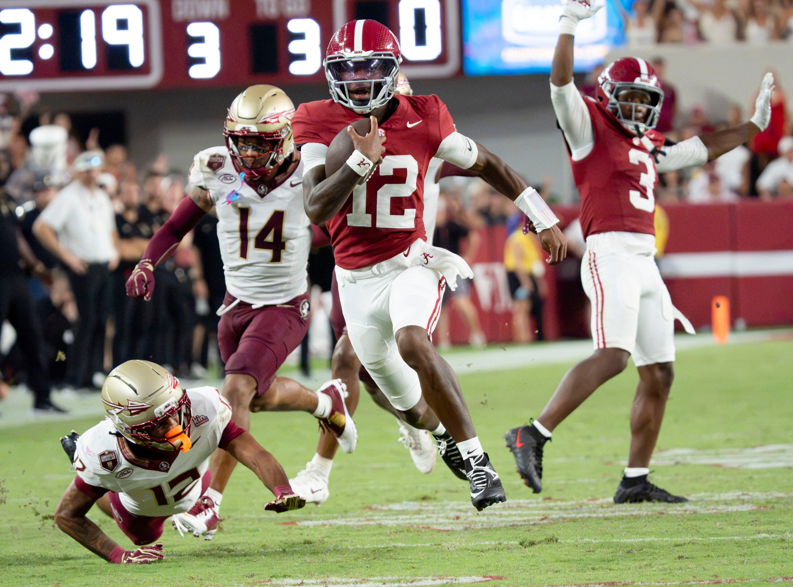Sep 19, 2026; Tuscaloosa, AL, USA; Alabama quarterback Keelon Russell (12) runs for a long touchdown past Florida State defensive back Ma'Khi Jones (14) and Florida State defensive back Nehemiah Chandler (12) at Bryant-Denny Stadium. Alabama defeated Florida State 50-36.
