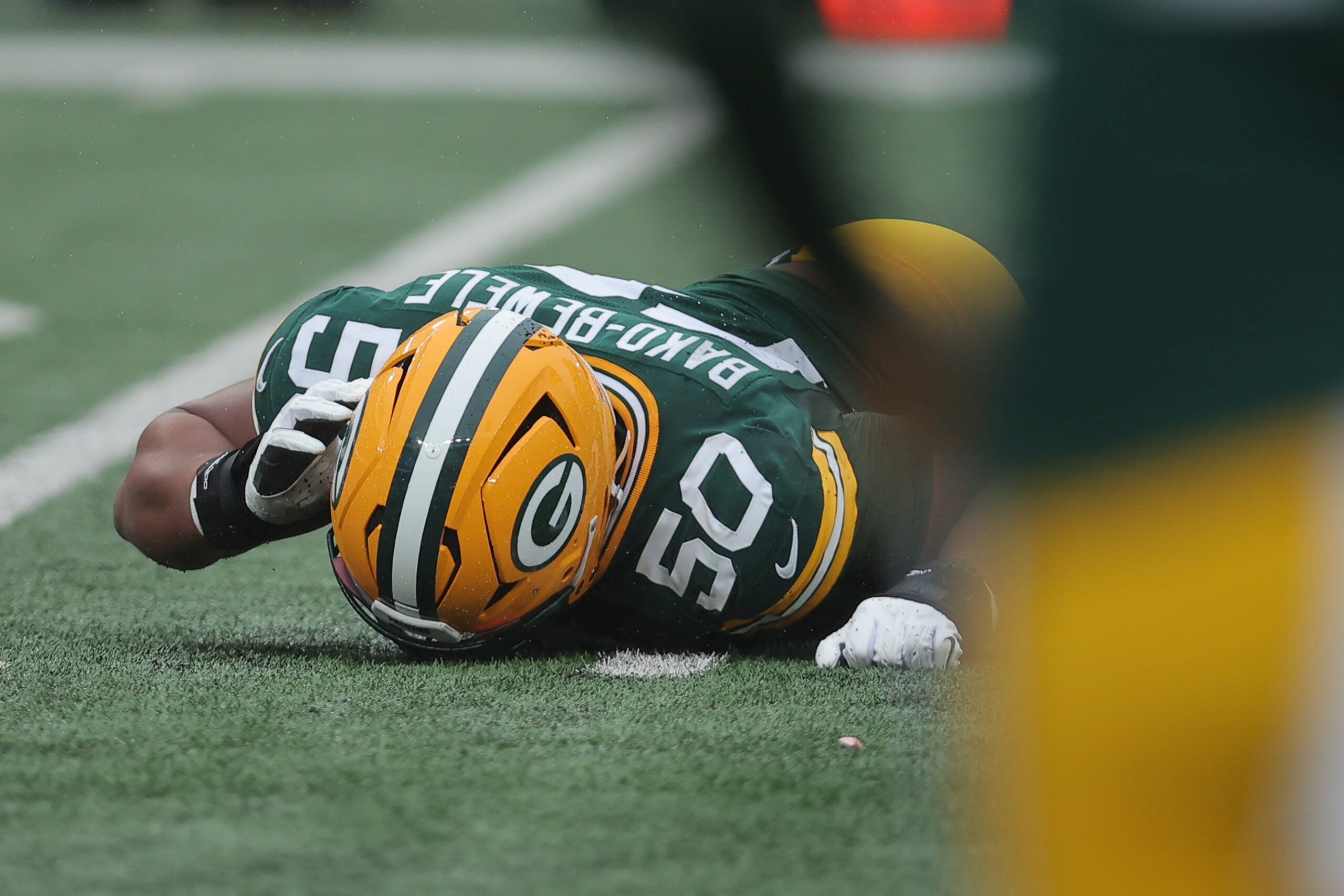Sep 20, 2026; East Rutherford, New Jersey, USA; Green Bay Packers offensive line Zach Bako-Bewele (50) lays on the turf with an apparent injury during the first quarter against the New York Jets at MetLife Stadium.
