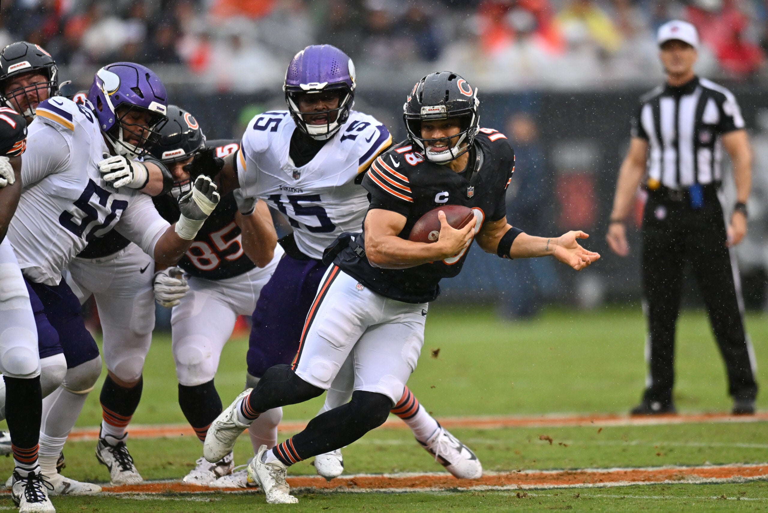 Sep 20, 2026; Chicago, Illinois, USA; Chicago Bears quarterback Caleb Williams (18) scrambles against Minnesota Vikings linebacker Dallas Turner (15) and defensive tackle Levi Drake Rodriguez (50) during the first quarter at Soldier Field.