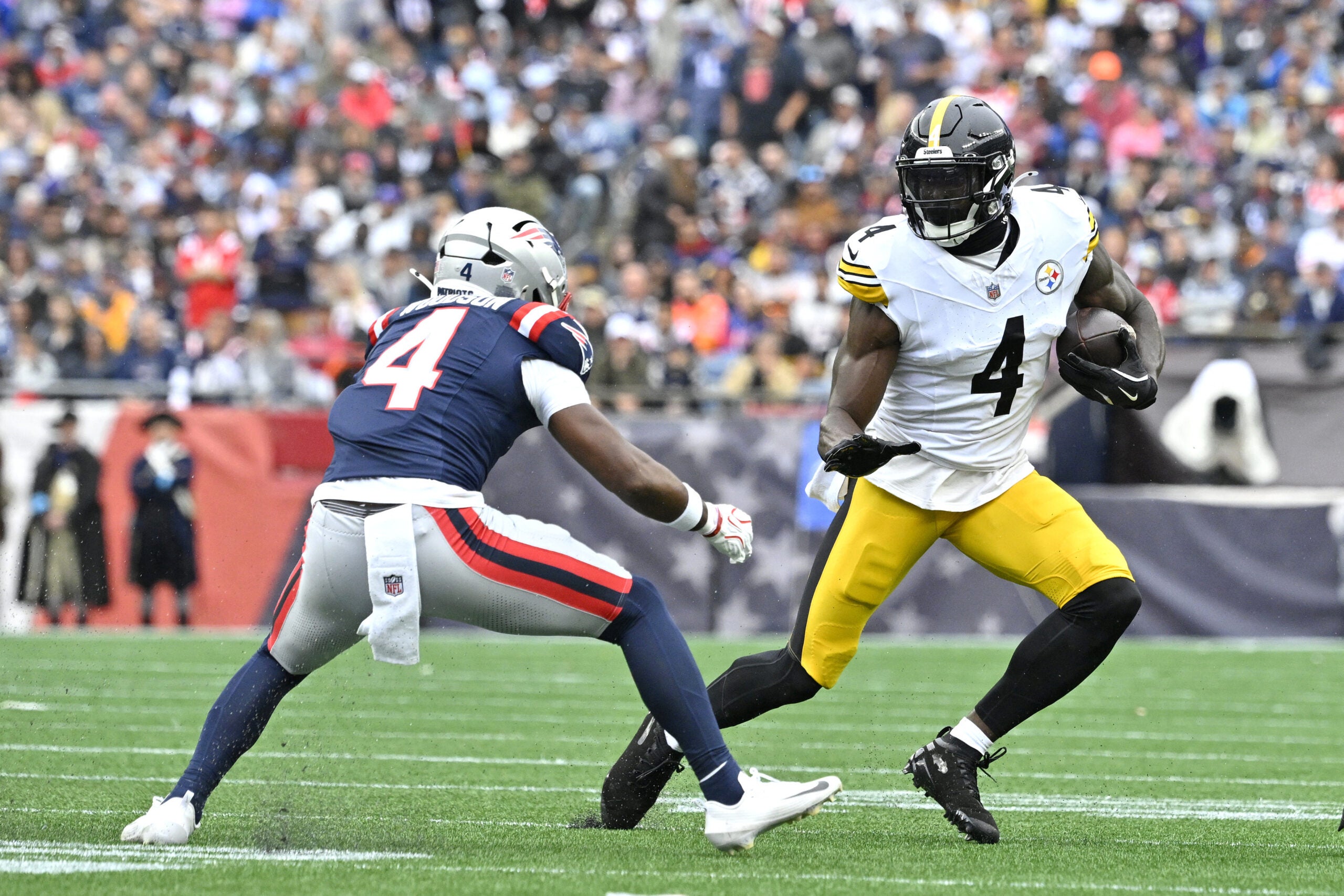 Sep 20, 2026; Foxborough, Massachusetts, USA; Pittsburgh Steelers wide receiver DK Metcalf (4) runs the ball against New England Patriots safety Craig Woodson (4) in the first half at Gillette Stadium.