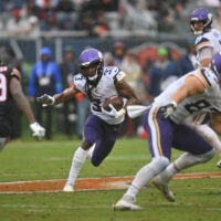 Sep 20, 2026; Chicago, Illinois, USA; Minnesota Vikings running back Aaron Jones Sr. (33) runs the ball against the Chicago Bears during the first half at Soldier Field.