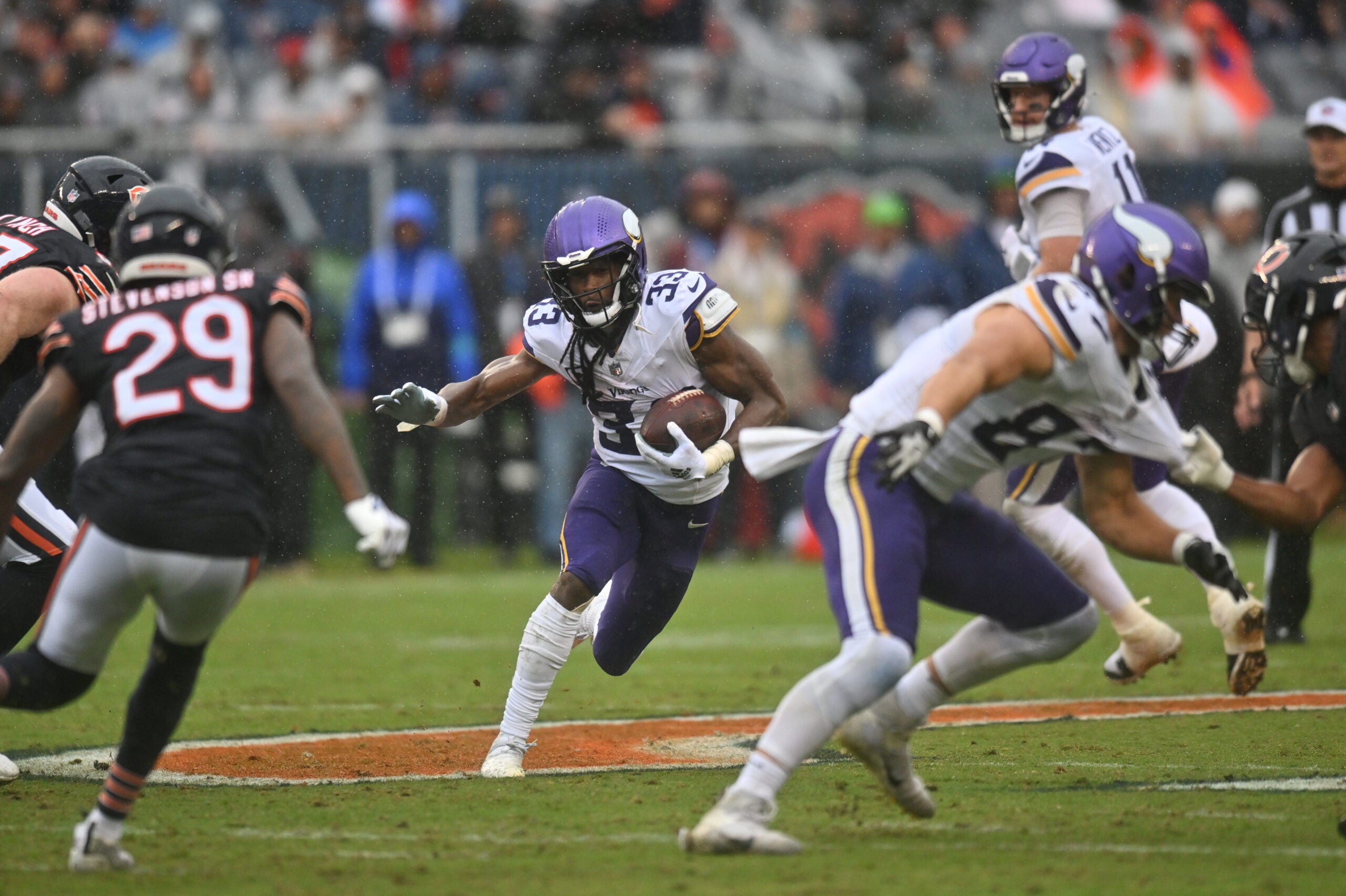 Sep 20, 2026; Chicago, Illinois, USA; Minnesota Vikings running back Aaron Jones Sr. (33) runs the ball against the Chicago Bears during the first half at Soldier Field.