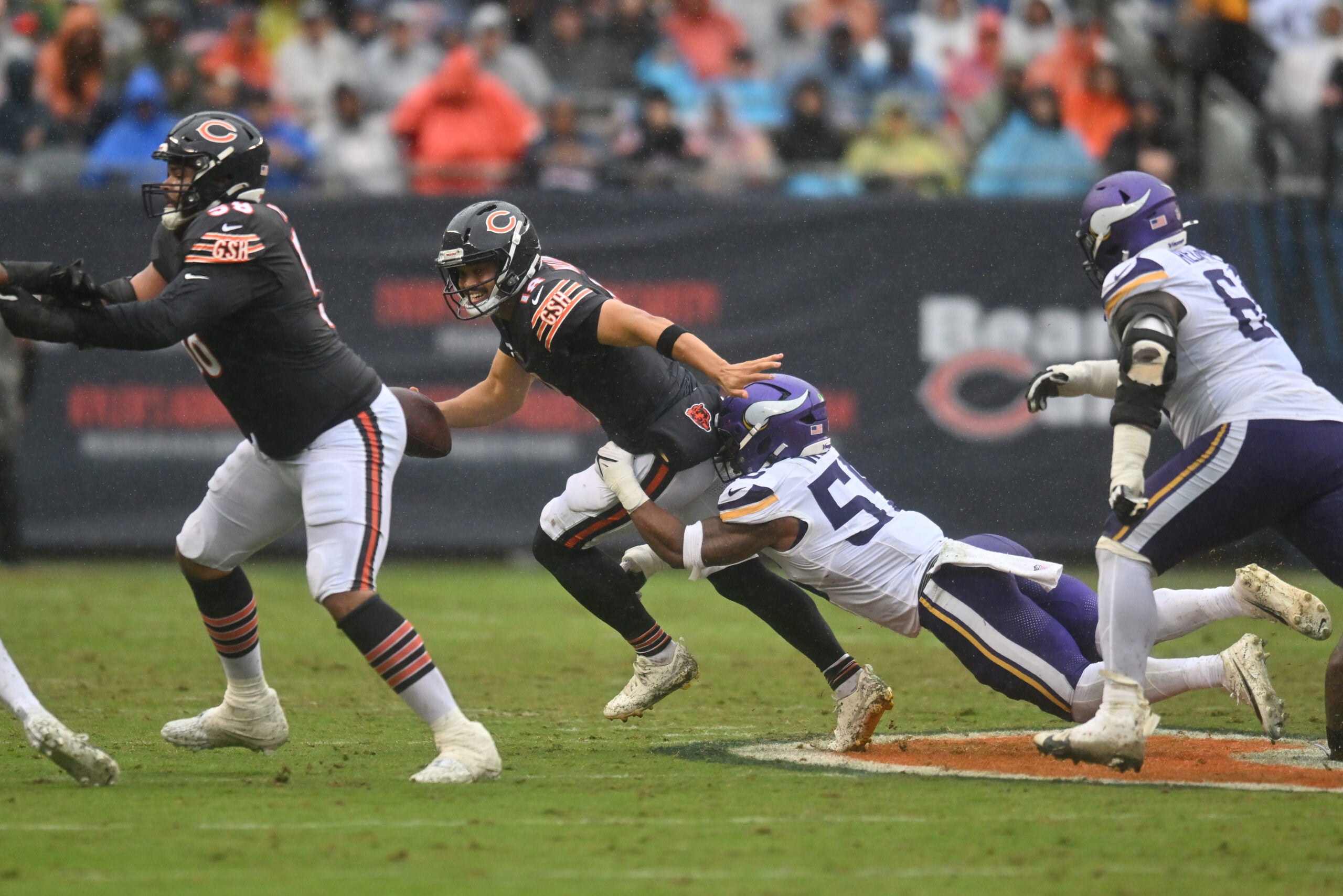 Sep 20, 2026; Chicago, Illinois, USA; Chicago Bears quarterback Caleb Williams (18) scrambles against Minnesota Vikings linebacker Eric Wilson (55) during the first half at Soldier Field.
