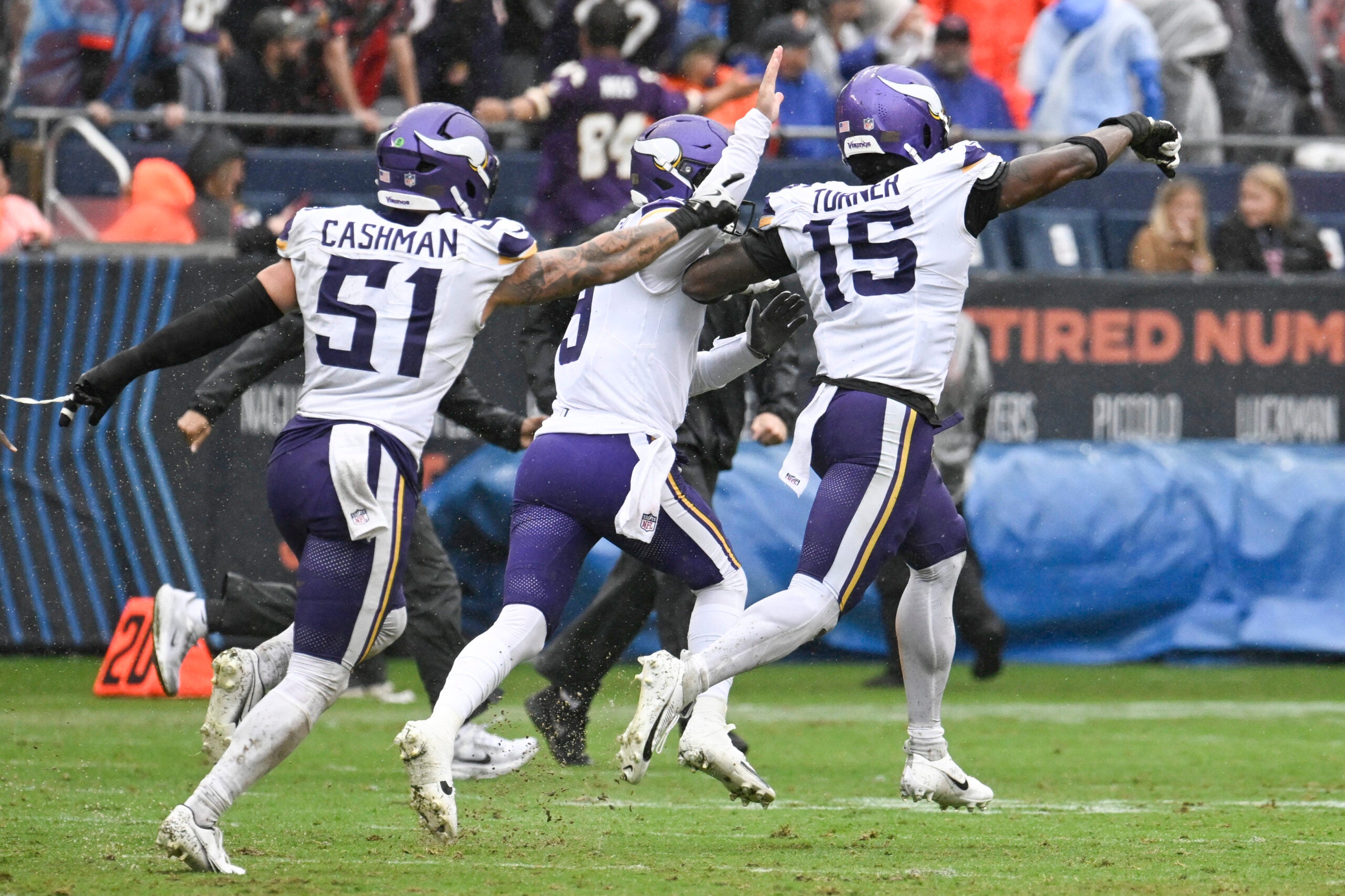 Sep 20, 2026; Chicago, Illinois, USA; Minnesota Vikings linebacker Dallas Turner (obscured) celebrates with linebacker Blake Cashman (51) and quarterback J.J. McCarthy (9) after sacking Chicago Bears quarterback Tyson Bagent (not pictured) to end the game in the second half at Soldier Field.