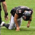 Sep 20, 2026; Chicago, Illinois, USA; Chicago Bears quarterback Caleb Williams (18) kneels on the field with an apparent injury against the Minnesota Vikings during the second half at Soldier Field.
