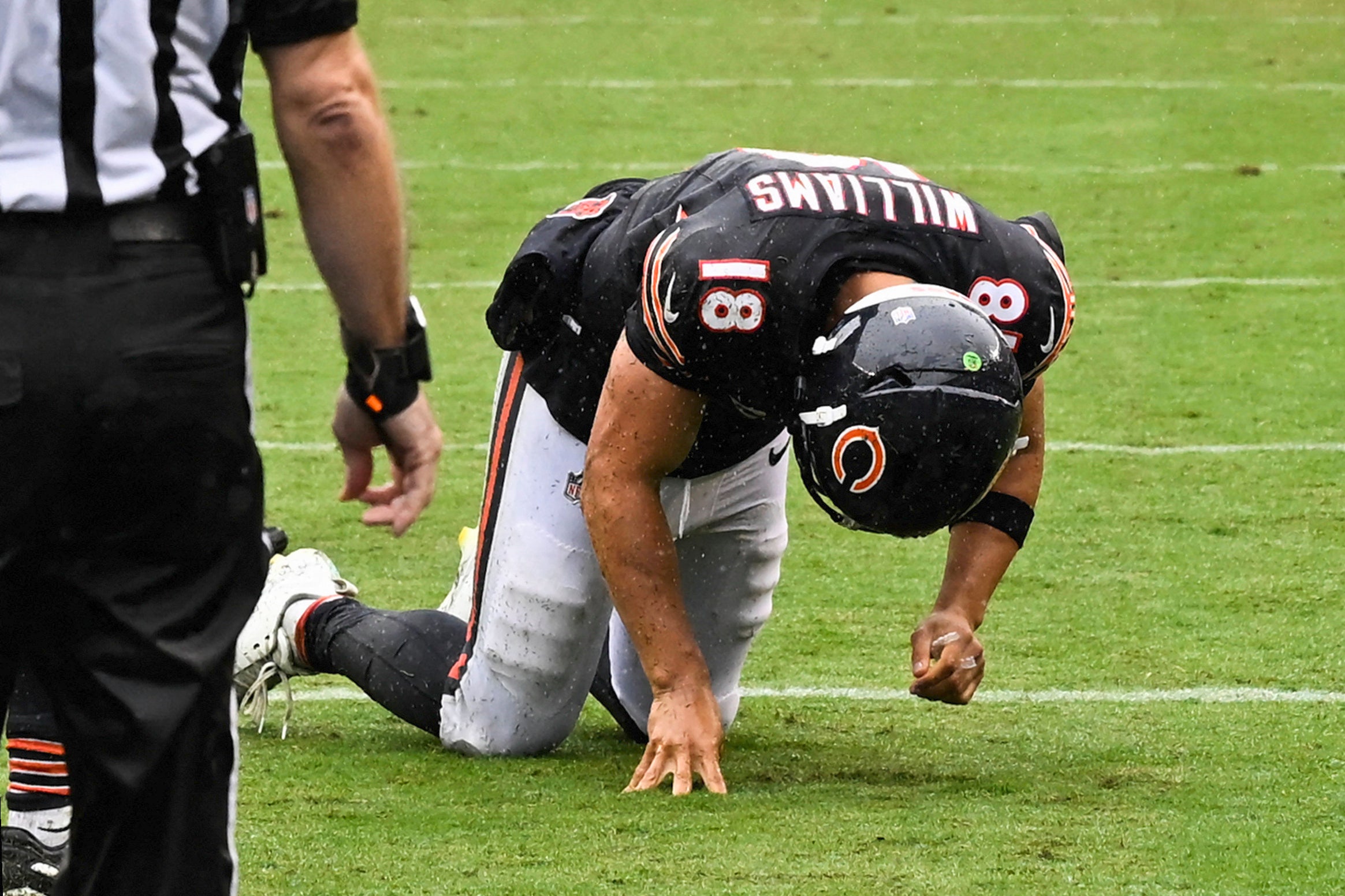 Sep 20, 2026; Chicago, Illinois, USA; Chicago Bears quarterback Caleb Williams (18) kneels on the field with an apparent injury against the Minnesota Vikings during the second half at Soldier Field.