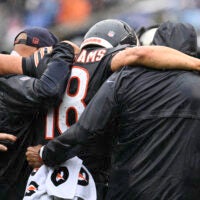 Sep 20, 2026; Chicago, Illinois, USA; Chicago Bears quarterback Caleb Williams (18) is helped off the field with an apparent injury against the Minnesota Vikings during the second half at Soldier Field.