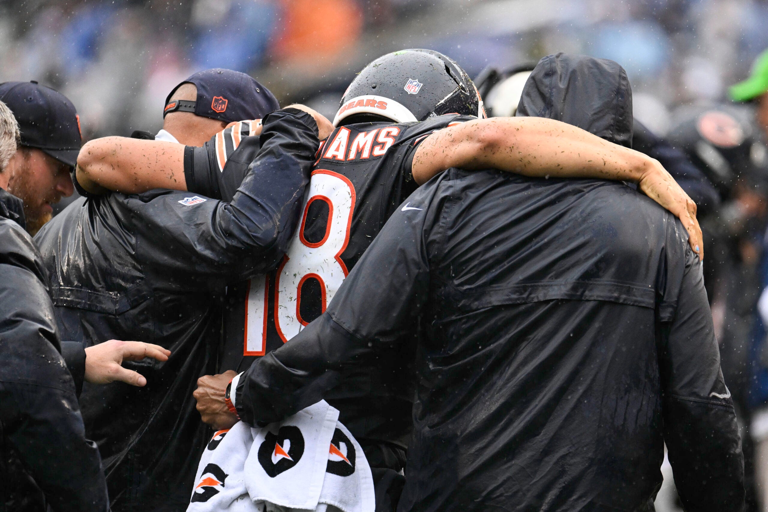 Sep 20, 2026; Chicago, Illinois, USA; Chicago Bears quarterback Caleb Williams (18) is helped off the field with an apparent injury against the Minnesota Vikings during the second half at Soldier Field.
