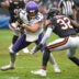 Sep 20, 2026; Chicago, Illinois, USA; Minnesota Vikings tight end T.J. Hockenson (87) runs against Chicago Bears defensive back Xavier Woods (32) during the second half at Soldier Field.