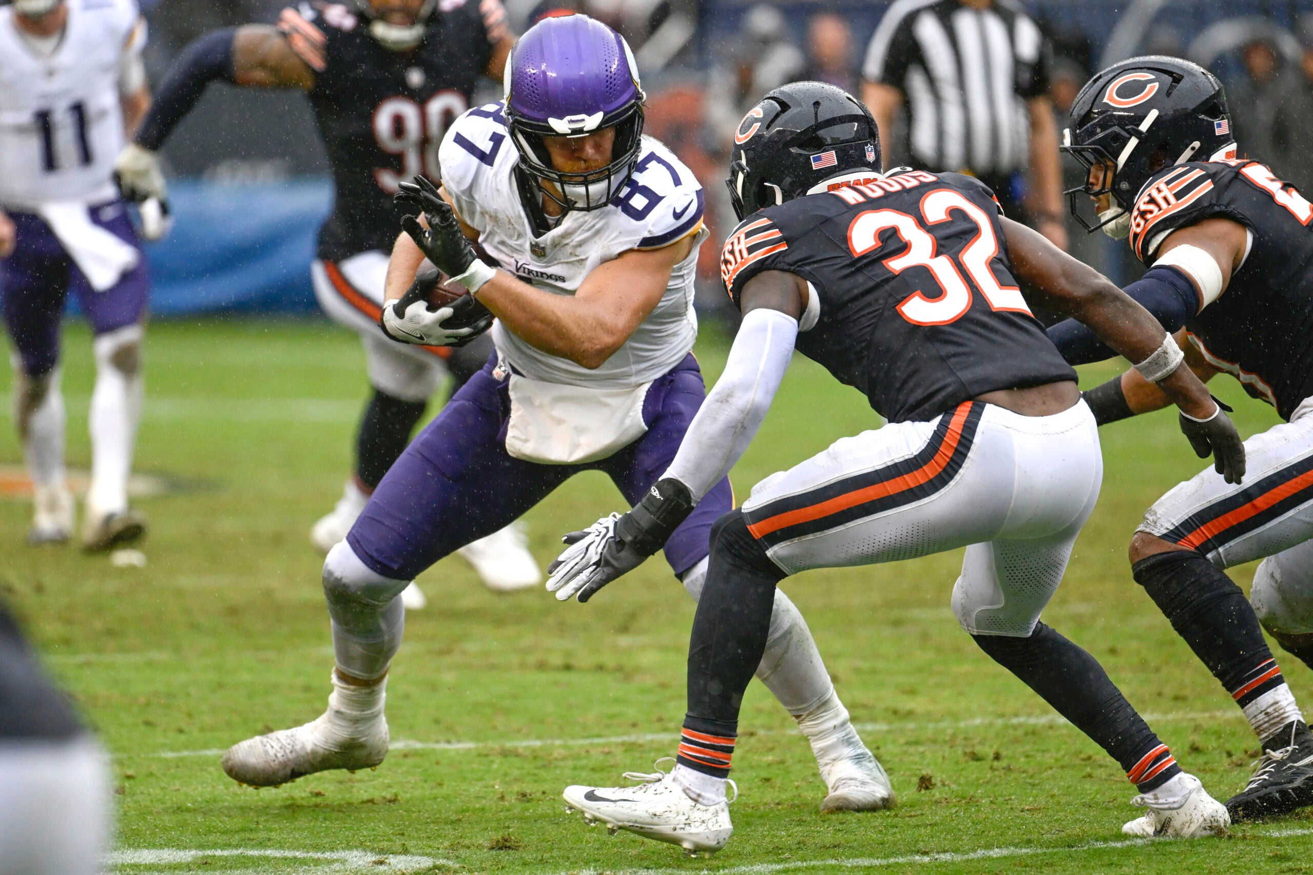 Sep 20, 2026; Chicago, Illinois, USA; Minnesota Vikings tight end T.J. Hockenson (87) runs against Chicago Bears defensive back Xavier Woods (32) during the second half at Soldier Field.