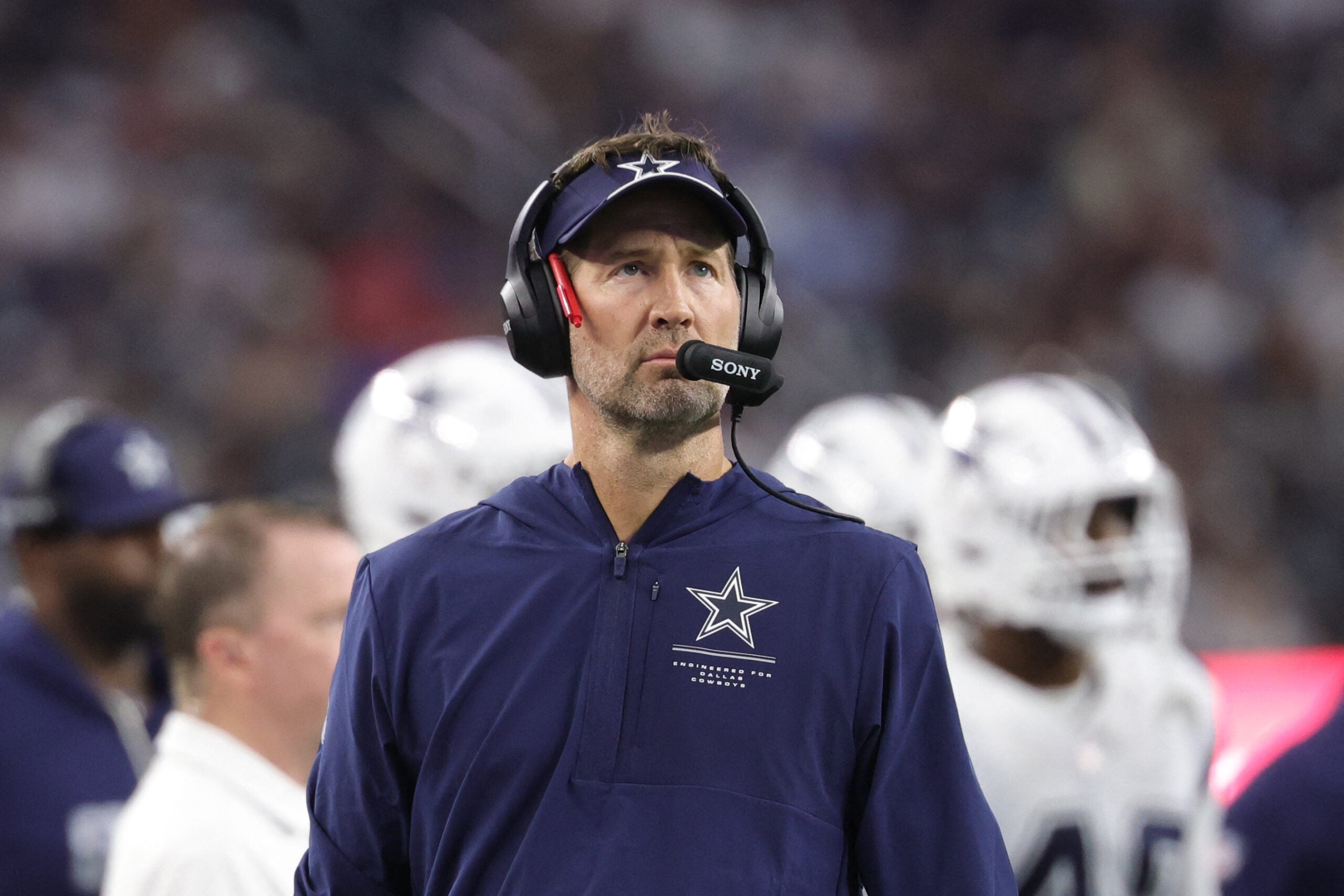 Sep 20, 2026; Arlington, Texas, USA; Dallas Cowboys head coach Brian Schottenheimer watches the video scoreboard during a stoppage of play against the Washington Commanders in the second half at AT&T Stadium.
