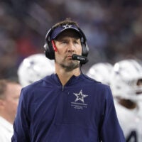 Sep 20, 2026; Arlington, Texas, USA; Dallas Cowboys head coach Brian Schottenheimer watches the video scoreboard during a stoppage of play against the Washington Commanders in the second half at AT&T Stadium.