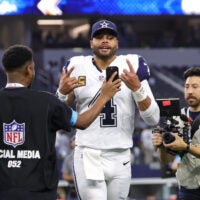Sep 20, 2026; Arlington, Texas, USA; Dallas Cowboys quarterback Dak Prescott (4) jogs off the field and reacts for an NFL social media creator after a game against the Washington Commanders at AT&T Stadium.