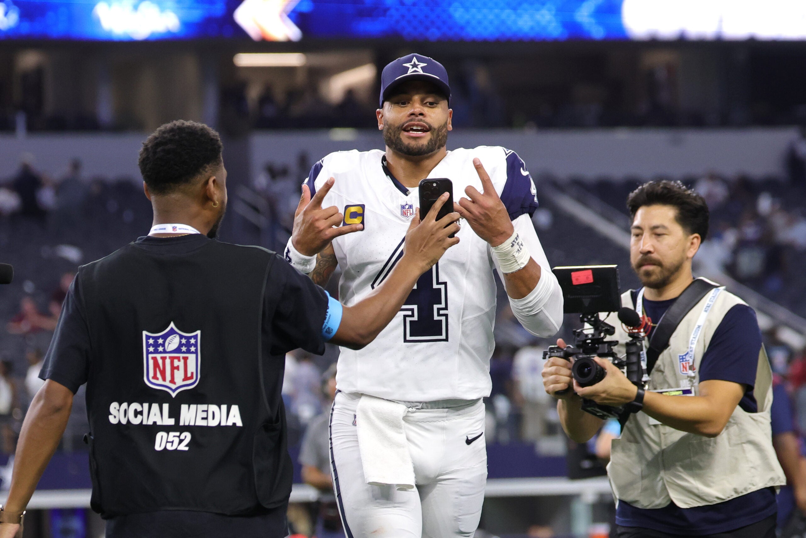 Sep 20, 2026; Arlington, Texas, USA; Dallas Cowboys quarterback Dak Prescott (4) jogs off the field and reacts for an NFL social media creator after a game against the Washington Commanders at AT&T Stadium.