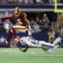Sep 20, 2026; Arlington, Texas, USA; Washington Commanders quarterback Jayden Daniels (5) leaps to avoid a tackle by Dallas Cowboys safety Caleb Downs (13) while running with the ball during the second half at AT&T Stadium.