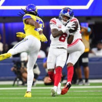Sep 21, 2026; Inglewood, California, USA; New York Giants safety Jevon Holland (8) makes an interception against Los Angeles Rams wide receiver Davante Adams (17) during the second quarter at SoFi Stadium.