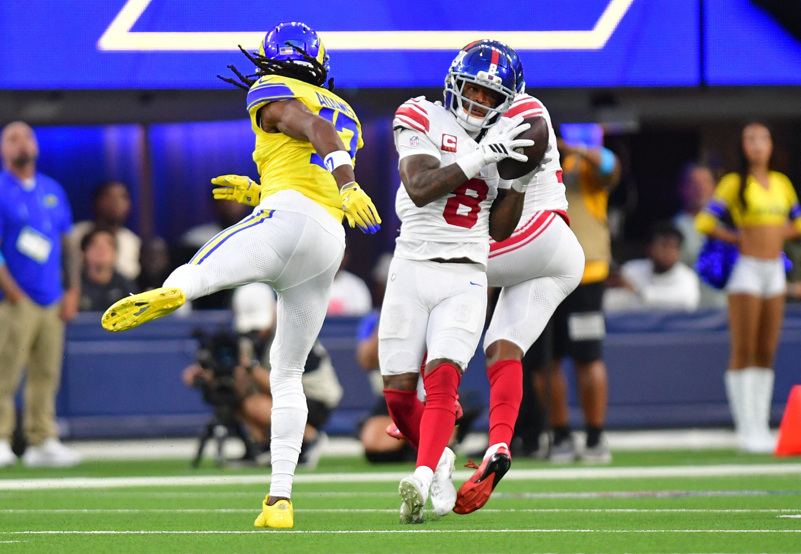 Sep 21, 2026; Inglewood, California, USA; New York Giants safety Jevon Holland (8) makes an interception against Los Angeles Rams wide receiver Davante Adams (17) during the second quarter at SoFi Stadium.
