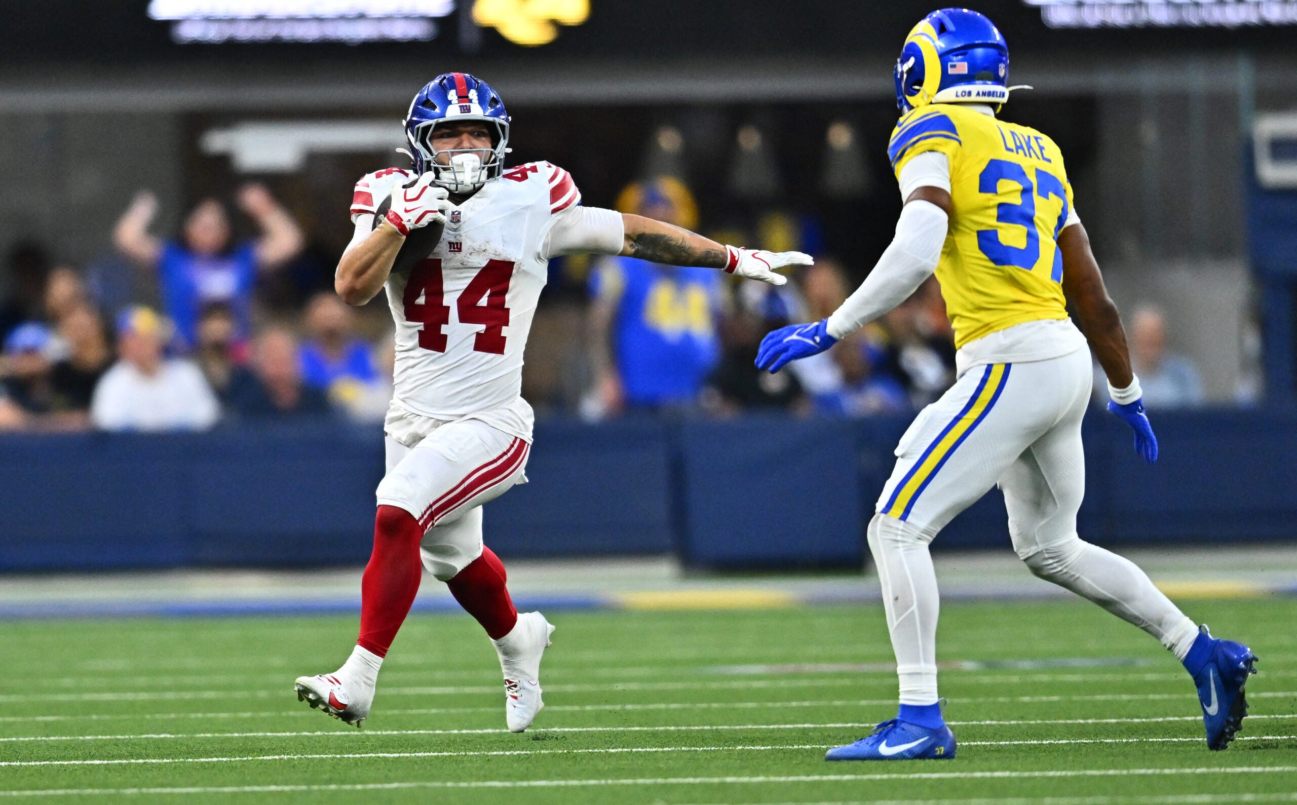Sep 21, 2026; Inglewood, California, USA; New York Giants running back Cam Skattebo (44) runs against Los Angeles Rams safety Quentin Lake (37) during the second quarter at SoFi Stadium.
