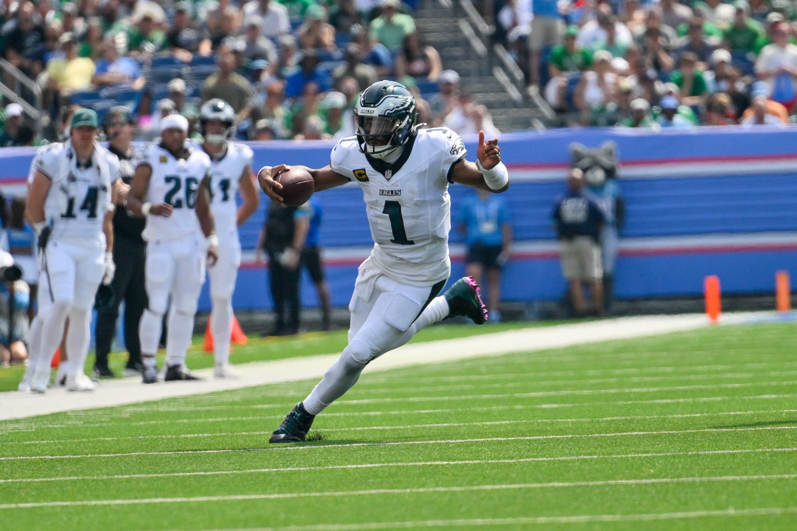 Sep 20, 2026; Nashville, Tennessee, USA; Philadelphia Eagles quarterback Jalen Hurts (1) scrambles against the Tennessee Titans during the first half at Nissan Stadium.