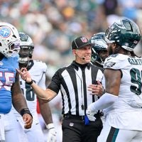 Sep 20, 2026; Nashville, Tennessee, USA; Referee Clay Martin talks with Philadelphia Eagles defensive tackle Jalen Carter (98) and Tennessee Titans offensive tackle JC Latham (55) during a time out during the second half at Nissan Stadium.