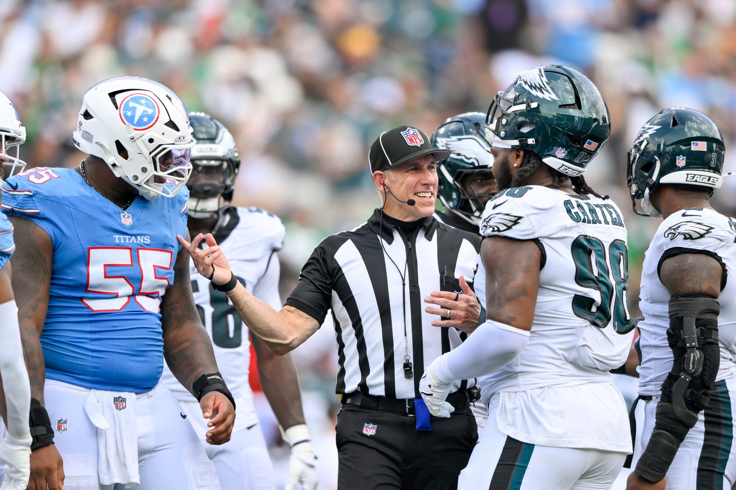 Sep 20, 2026; Nashville, Tennessee, USA; Referee Clay Martin talks with Philadelphia Eagles defensive tackle Jalen Carter (98) and Tennessee Titans offensive tackle JC Latham (55) during a time out during the second half at Nissan Stadium.
