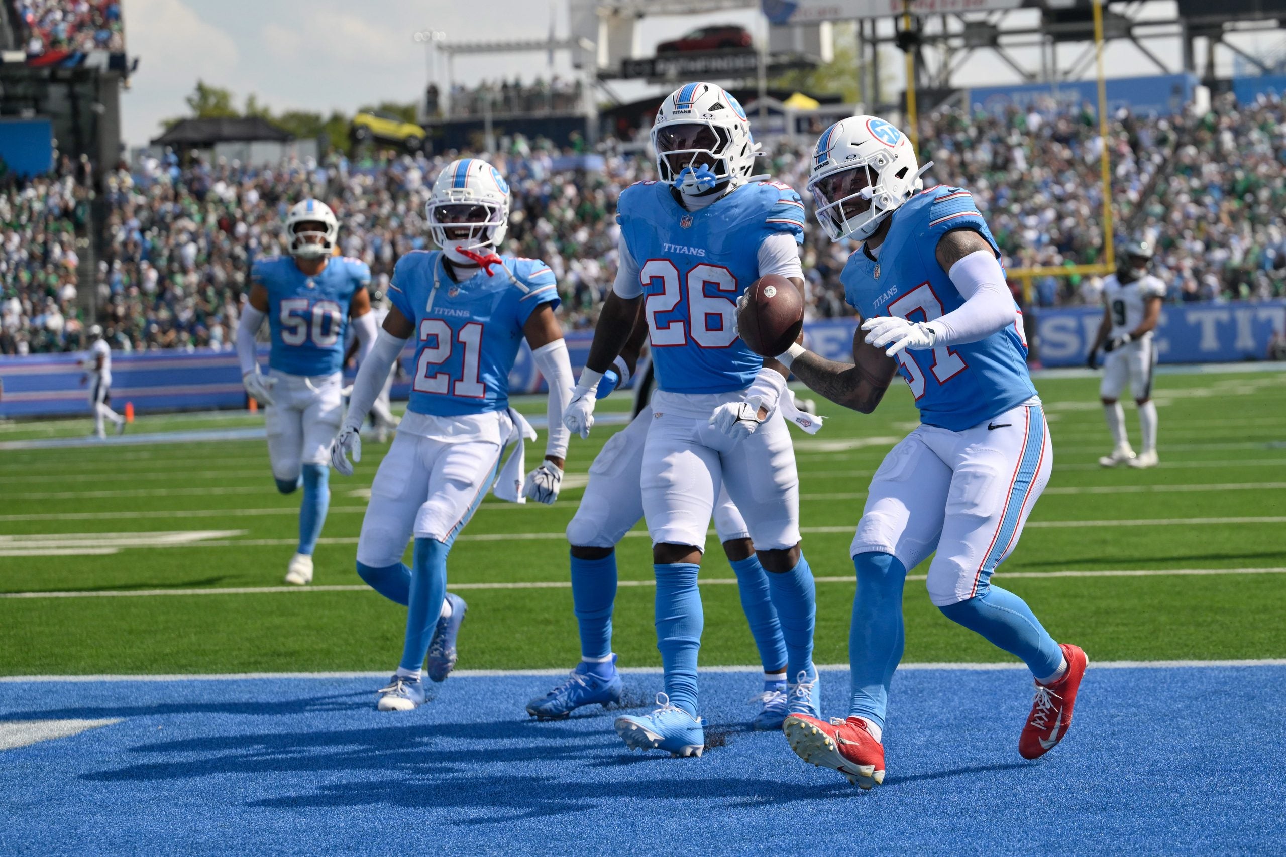 Sep 20, 2026; Nashville, Tennessee, USA; Philadelphia Eagles running back Saquon Barkley (26) celebrates his interception with safety Ammani Hooker (37) and cornerback Micah Robinson (21) against the Philadelphia Eagles during the second half at Nissan Stadium.