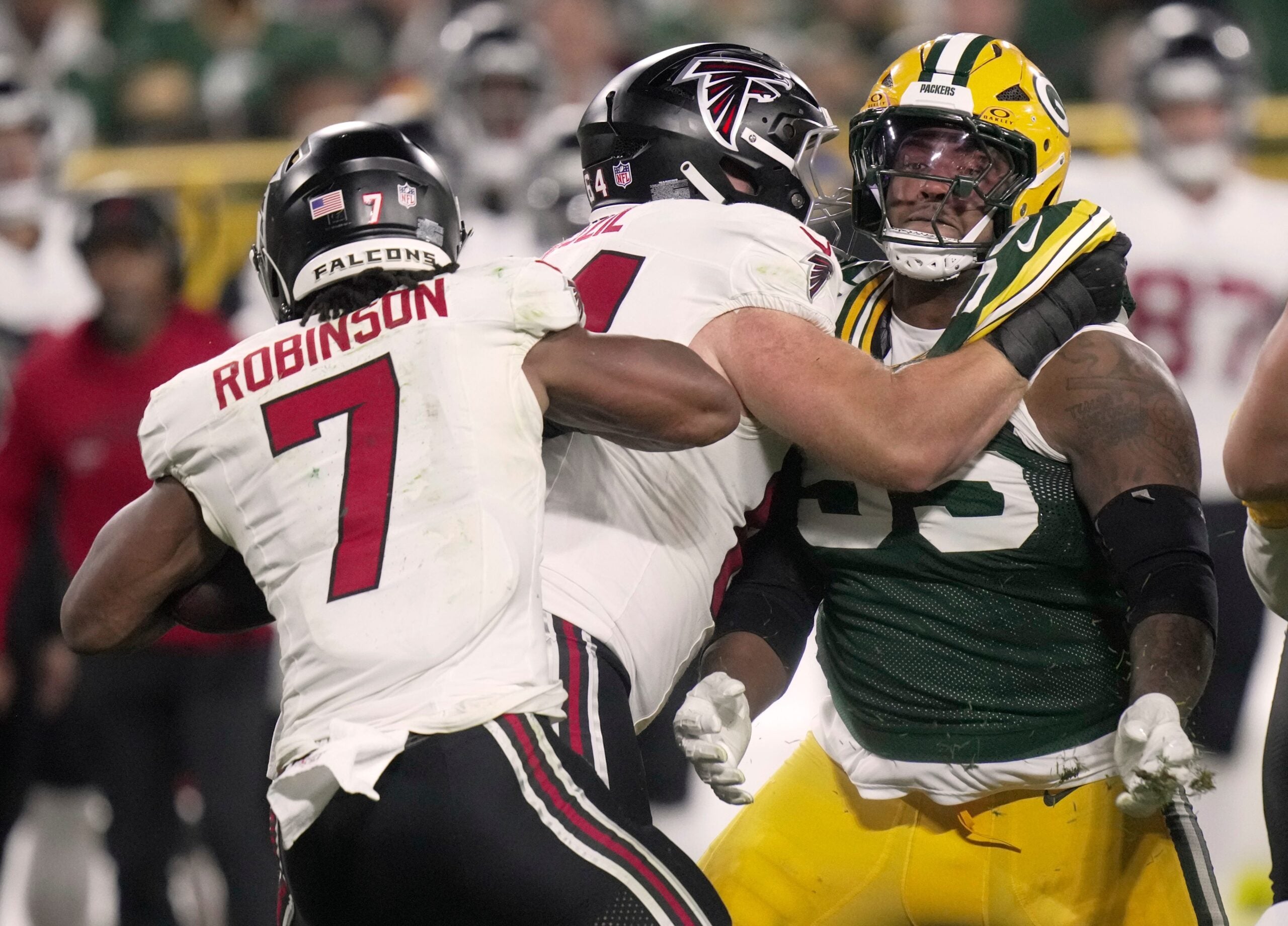 Green Bay Packers defensive tackle Chris McClellan (55) is blocked from tackling Atlanta Falcons running back Bijan Robinson (7) during the fourth quarter of their game Thursday, Sept. 24, 2026 at Lambeau Field in Green Bay, Wisconsin. The Atlanta Falcons beat there Green Bay Packers 35-14.