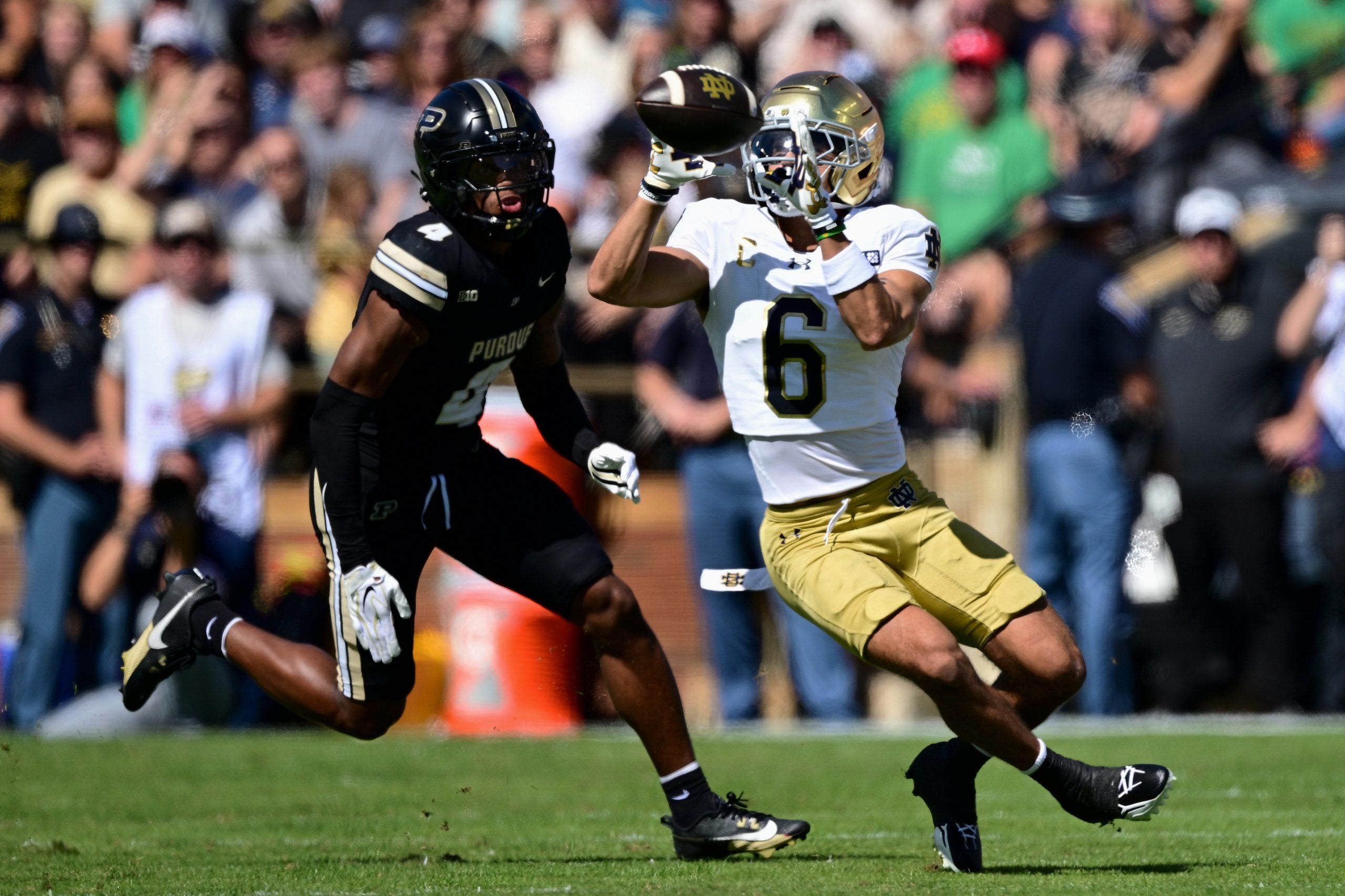Sep 26, 2026; West Lafayette, Indiana, USA; Notre Dame Fighting Irish wide receiver Jordan Faison (6) makes a catch ahead of Purdue Boilermakers defensive back Hudauri Hines (4) in the first quarter at Ross-Ade Stadium.