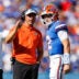 Sep 26, 2026; Gainesville, Florida, USA; Florida Gators head coach Jon Sumrall talks with quarterback Aaron Philo (12) during a timeout against the Mississippi Rebels during the first half at Ben Hill Griffin Stadium.