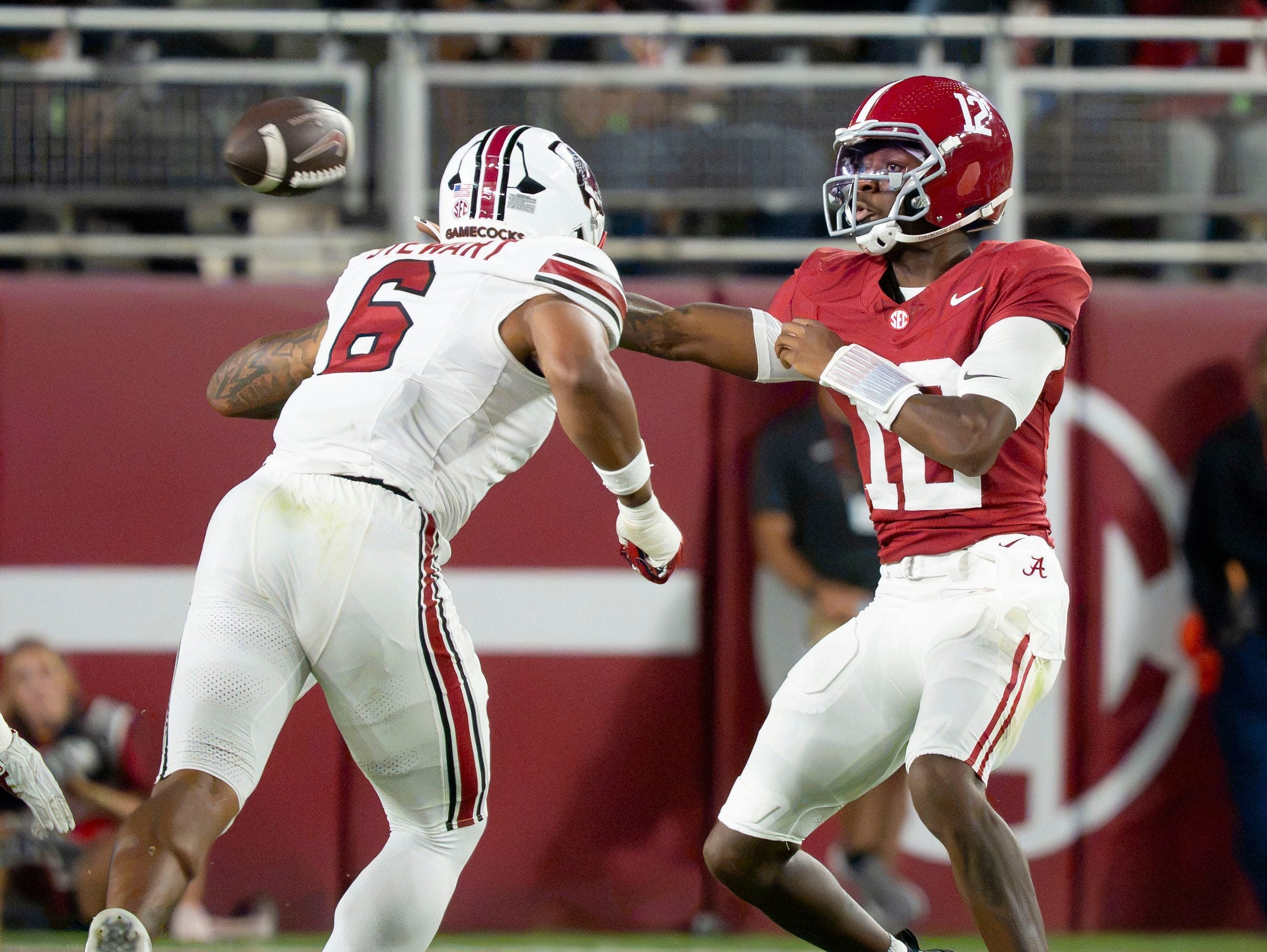 Sep 26, 2026; Tuscaloosa, AL, USA; Alabama quarterback Keelon Russell (12) makes a sidearm throw around South Carolina edge rusher Dylan Stewart (6) at Saban Field at Bryant Denny Stadium.