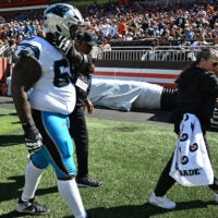 Sep 27, 2026; Cleveland, Ohio, USA; Carolina Panthers guard Damien Lewis (68) walks off the field with medical staff during the first half Cleveland Browns at Huntington Bank Field.