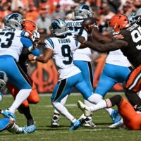 Sep 27, 2026; Cleveland, Ohio, USA; Carolina Panthers quarterback Bryce Young (9) passes the ball under pressure from Cleveland Browns defensive tackle Maliek Collins (96) during the second quarter at Huntington Bank Field.