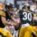 Pittsburgh Steelers quarterback Aaron Rodgers (8) fakes a hand off to running back Jaylen Warren (30) in the second quarter of the NFL Week 3 game between the Pittsburgh Steelers and the Cincinnati Bengals at Acrisure Stadium in Pittsburgh on Sunday, Sept. 27, 2026. The game was tied at 17 at halftime.