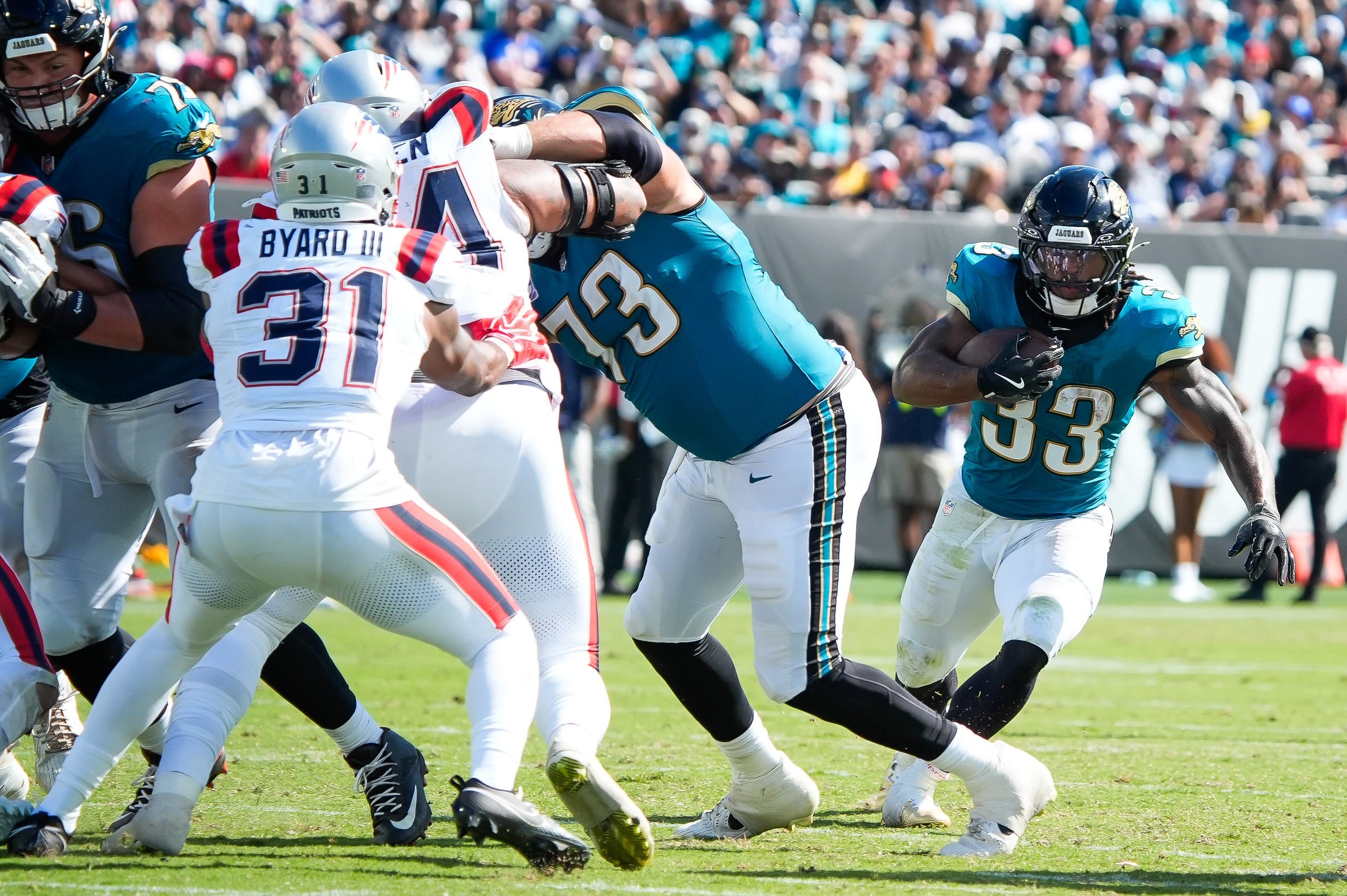 Jacksonville Jaguars running back Bhayshul Tuten (33) finds a hole in the fourth quarter during an NFL football game at EverBank Stadium, Sunday, September 27, 2026, in Jacksonville, Fla.