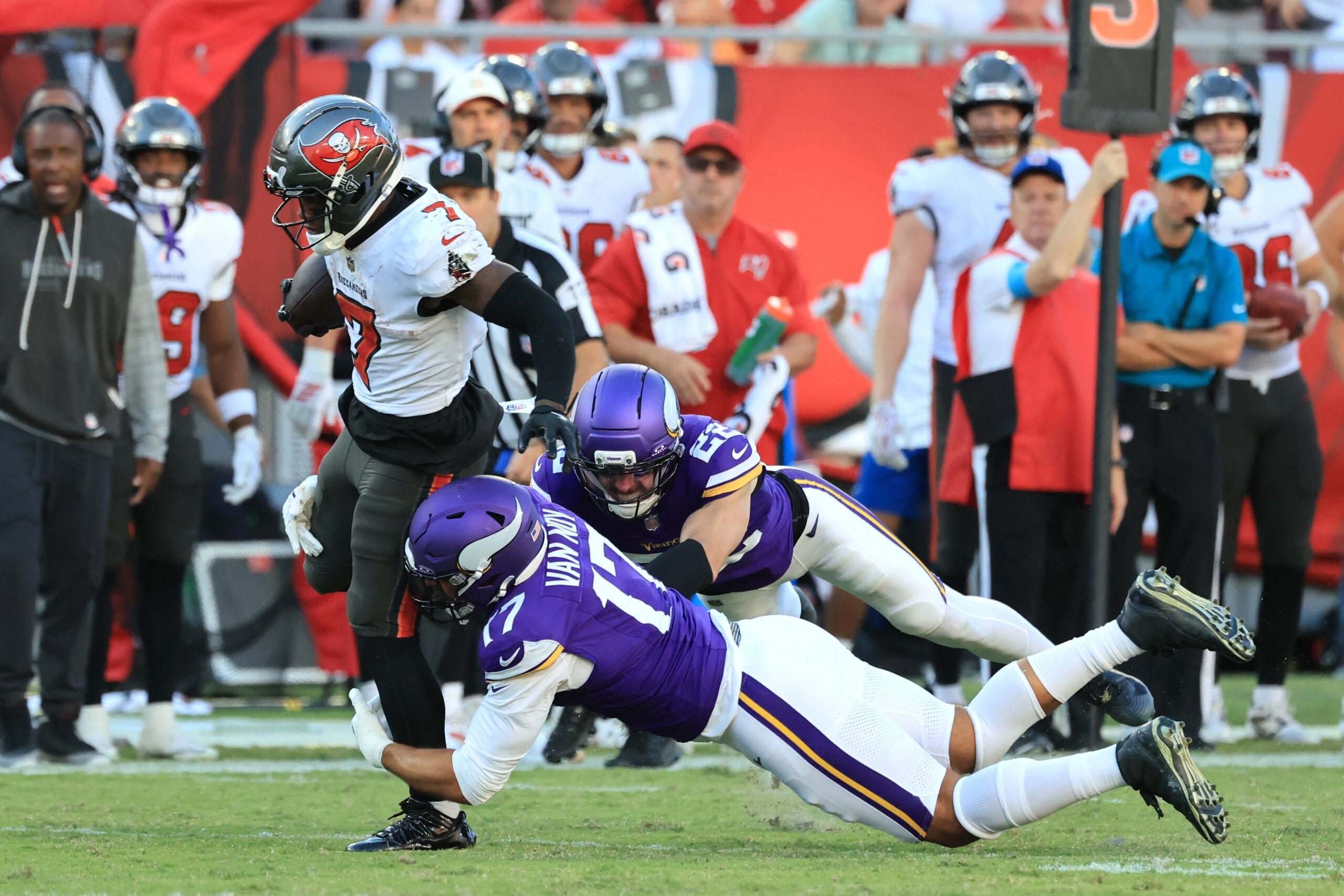 Sep 27, 2026; Tampa, Florida, USA; Tampa Bay Buccaneers running back Bucky Irving (7) carries the ball defended by Minnesota Vikings linebacker Kyle Van Noy (17) and safety Harrison Smith (22) during the third quarter at Raymond James Stadium.