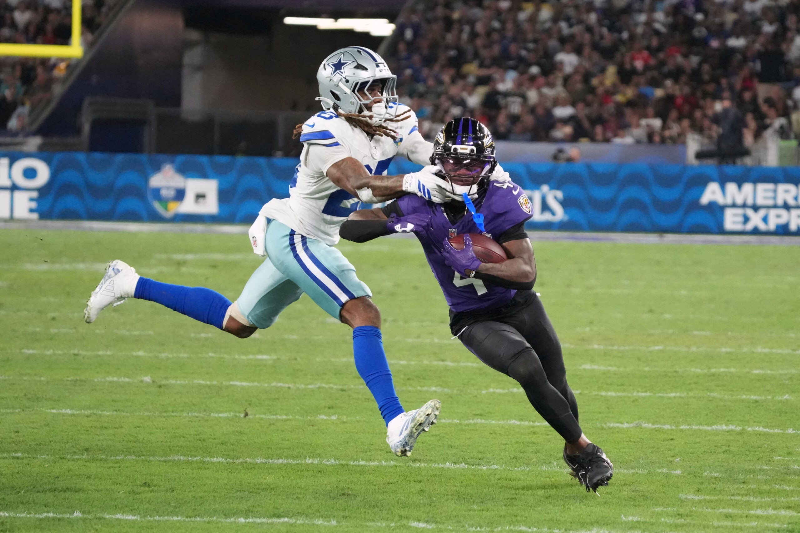 Sep 27, 2026; Rio De Janeiro, BRA; Baltimore Ravens wide receiver Zay Flowers (4) is tackled by Dallas Cowboys cornerback Shavon Revel Jr. (28) during the game at Maracana Stadium.