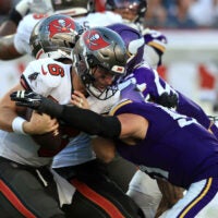 Sep 27, 2026; Tampa, Florida, USA; Minnesota Vikings linebacker Blake Cashman (51) tackles Tampa Bay Buccaneers quarterback Baker Mayfield (6) during the fourth quarter at Raymond James Stadium.