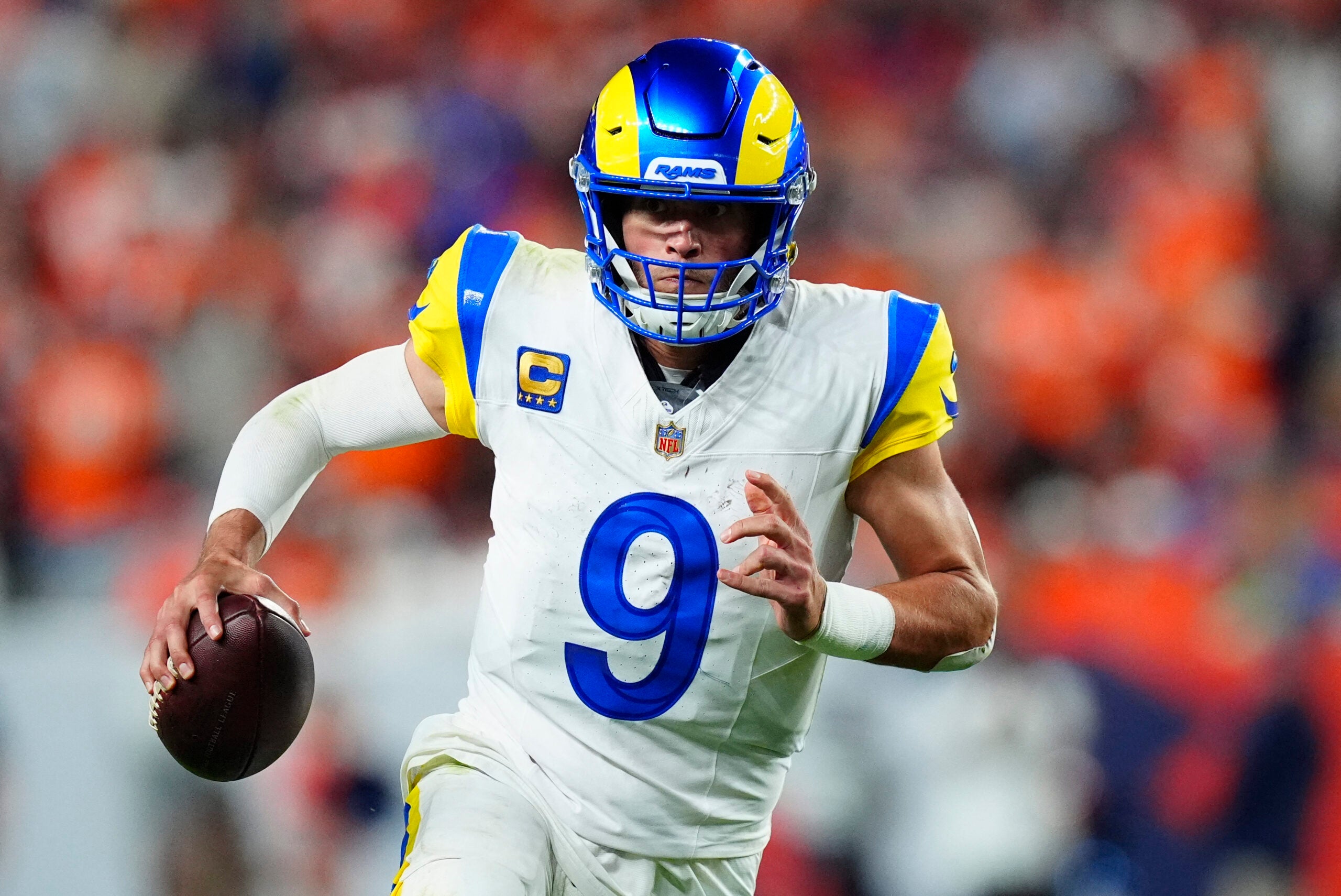 Sep 27, 2026; Denver, Colorado, USA; Los Angeles Rams quarterback Matthew Stafford (9) runs against the Denver Broncos during the second halfat Empower Field at Mile High.