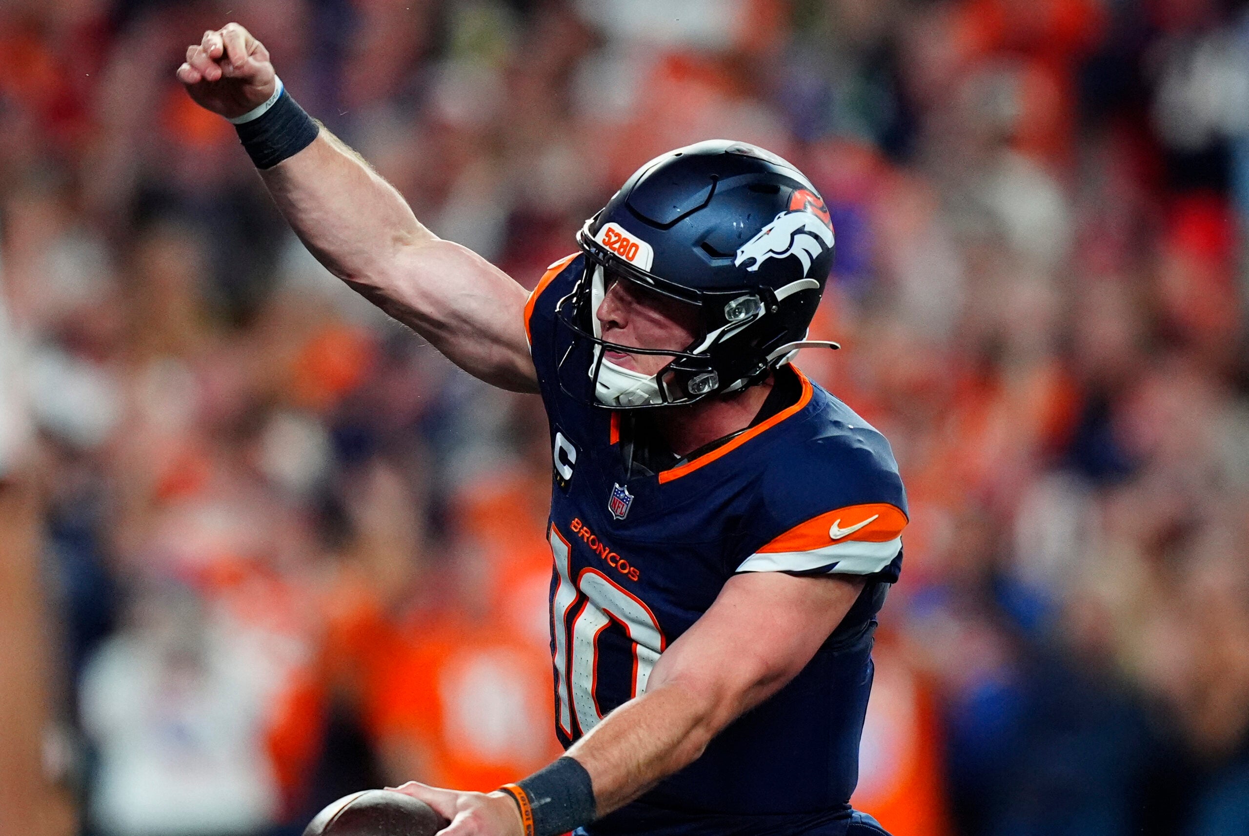 Sep 27, 2026; Denver, Colorado, USA; Denver Broncos quarterback Bo Nix (10) celebrates after scoring a touchdown against the Los Angeles Rams during the second half at Empower Field at Mile High.