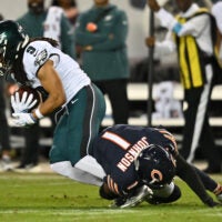 Sep 28, 2026; Chicago, Illinois, USA; Chicago Bears defensive back Jaylon Johnson (1) tackles Philadelphia Eagles wide receiver Makai Lemon (9) during the second half at Soldier Field.
