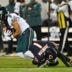 Sep 28, 2026; Chicago, Illinois, USA; Chicago Bears defensive back Jaylon Johnson (1) tackles Philadelphia Eagles wide receiver Makai Lemon (9) during the second half at Soldier Field.
