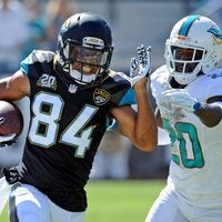 Oct 26, 2014; Jacksonville, FL, USA; Jacksonville Jaguars wide receiver Cecil Shorts III (84) runs the ball past Miami Dolphins safety Reshad Jones (20) during the first half of the game at EverBank Field.